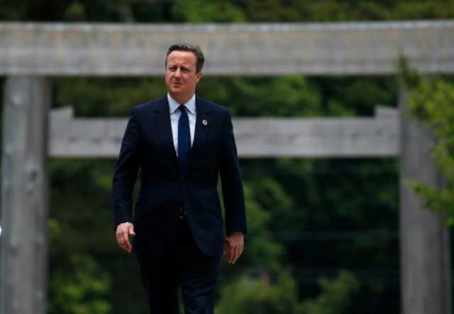 British Prime Minister David Cameron (R) walks on Ujibashi bridge as he visits Ise-Jingu S