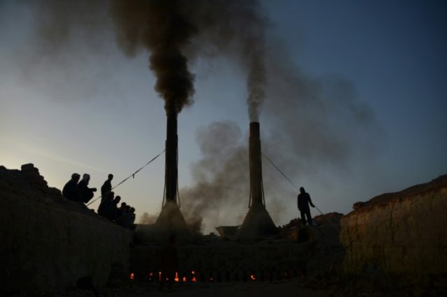 Afghan labourers work at a brick factory on the outskirts Mazar-i-Sharif on April 6, 2016