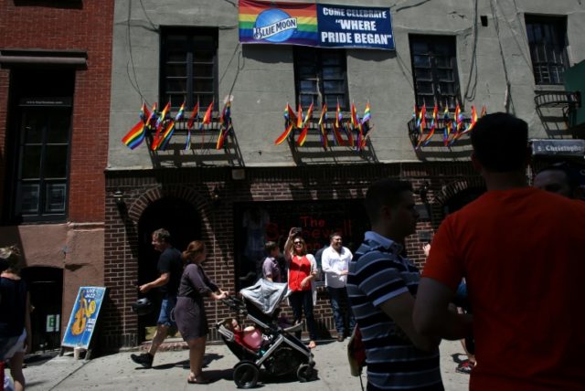 People gather outside of New York's Stonewall Inn, an iconic gay bar recently granted hist