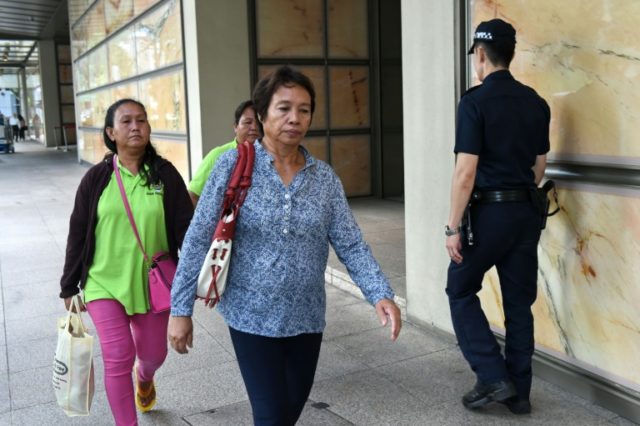 Lenduk Baling (C), the mother of Malaysian murder convict Kho Jabing, leaves the Supreme C