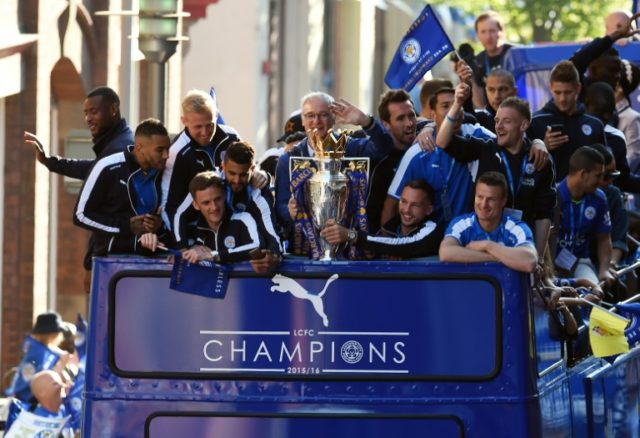 Leicester City's manager Claudio Ranieri (C) holds the Premier league trophy as the Leices