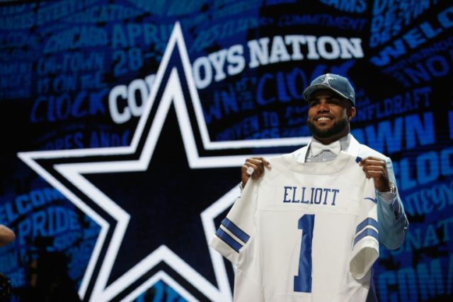 Ezekiel Elliott of Ohio State holds up a jersey after being picked #4 overall by the Dalla