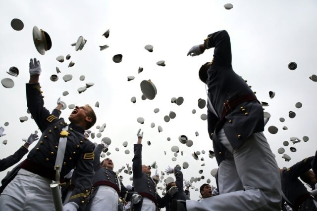 Cadets throw their hats in the air following their 2014 graduation ceremony at the US Mili