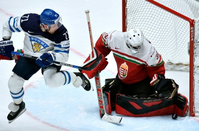 Finland's forward Leo Komarov (L) attacks Hungary's goalie Adam Vay on May 11, 2016