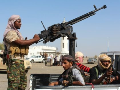 Forces loyal to the Saudi-backed Yemeni president stand on the back an armed vehicle on a
