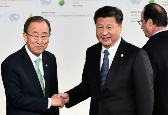 China's President Xi Jinping (R) shakes hands with United Nations Secretary General Ban Ki