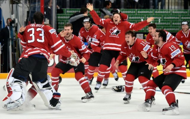 Canada's players celebrate on the ice shortly before the end of the gold medal game Finlan