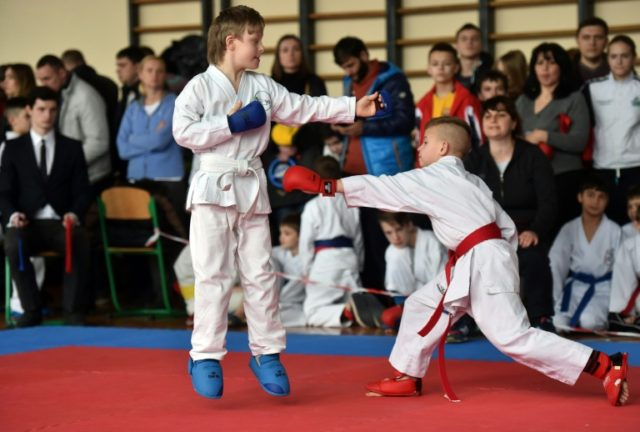 Ten-year-old Denys Nazarenko (L), who has Down's syndrome, takes part in a local karate c