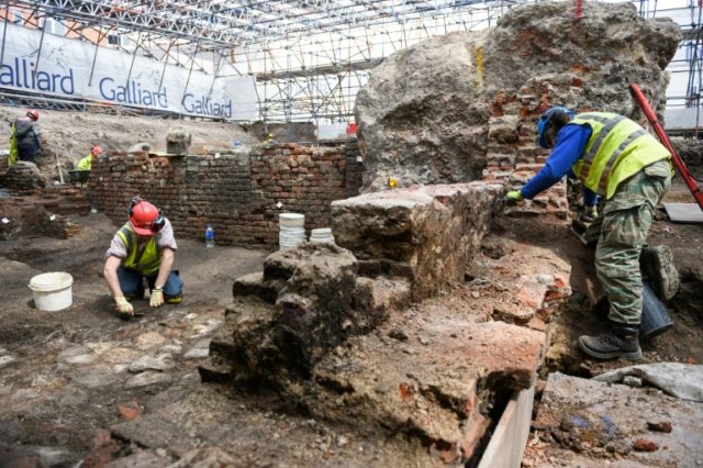An archeological team works on the site of the Curtain theatre in east London, on May 19,