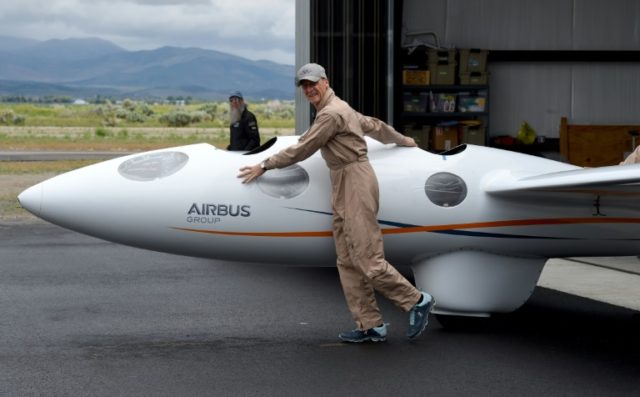 Airbus Group CEO Tom Enders pushes the Perlan 2 out of the hanger before he and chief pilo