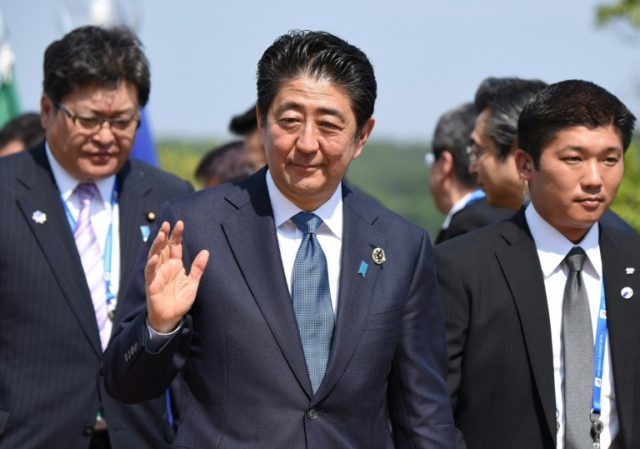 Reports suggest Japanese Prime Minister Shinzo Abe (C) is likely to leave the tricky work