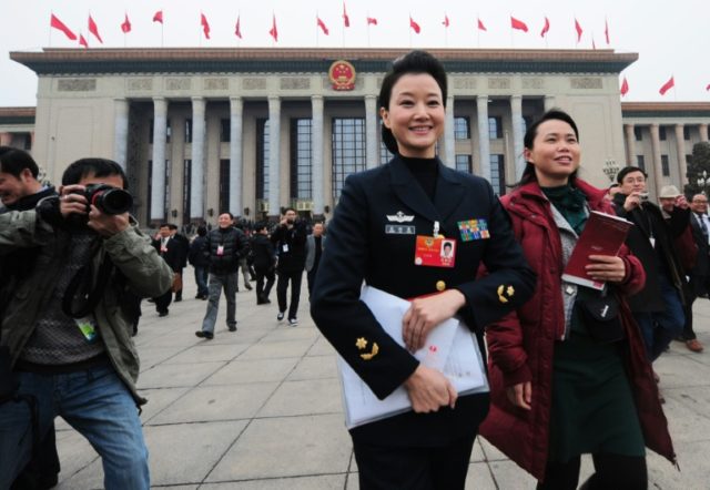 Delegate Song Zuying (C) leaves the Great Hall of the People after the opening session of