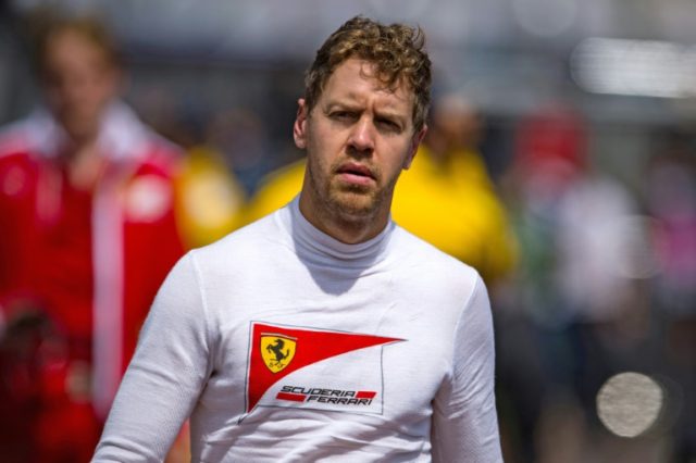 Ferrari driver Sebastian Vettel walks in the paddock during the first practice session for