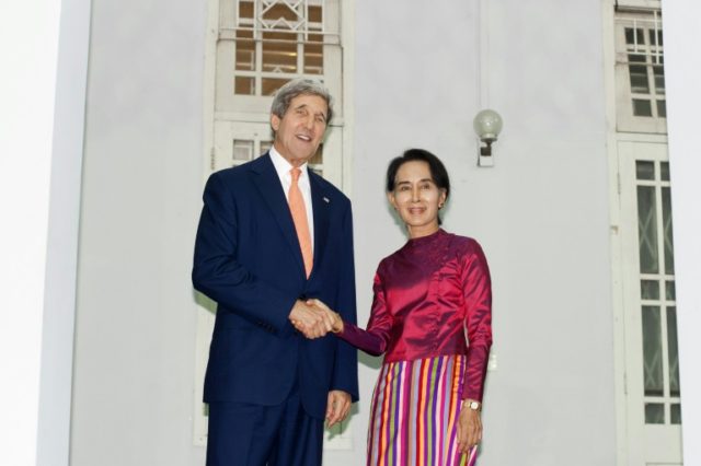 US Secretary of State John Kerry (L) shakes hands with Myanmar's Aung San Suu Kyi at her h