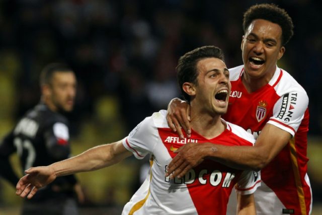 Monaco's top scorer Silva Bernardo (L) celebrates with teammate Helder Costa after scoring