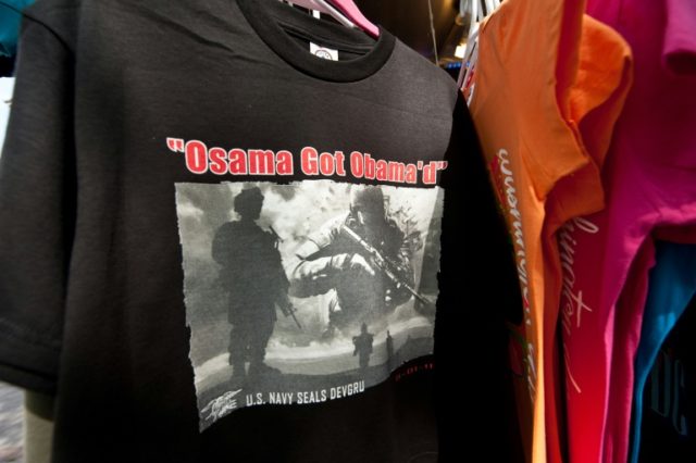 A T-shirt reading "Osama Got Obama'd" is displayed at a souvenir stand near the White Hous