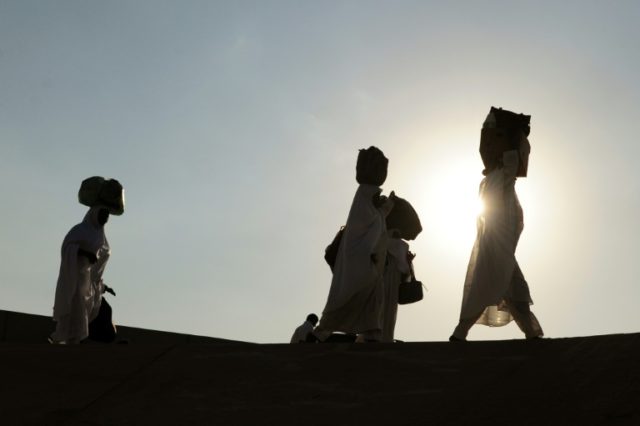 Muslim pilgrims arrive at the Mina valley five kilometres (three miles) east of the Saudi