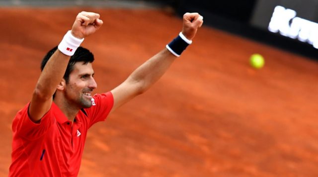Serbia's Novak Djokovic celebrates his victory over Spain's Rafael Nadal at the end of the