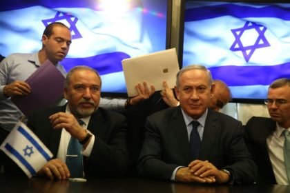 Israeli Prime Minister Benjamin Netanyahu (R) and Avigdor Lieberman (L), the head of hardline nationalist party Yisrael Beitenu, sign a coalition agreement on May 25, 2016 at the Knesset