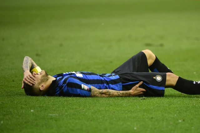 Inter Milan's forward Mauro Icardi lies injured on the pitch on May 7, 2016