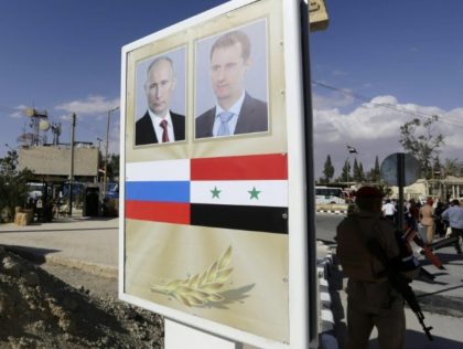 A poster in Syria's ancient city of Palmyra, captured from Islamic State militants by Russian-backed Syrian forces, bears a portrait of Syrian President Bashar al-Assad (R) and Russian President Vladimir Putin