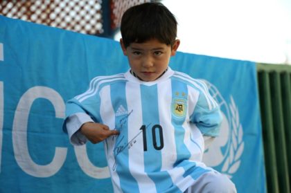 Afghan boy Murtaza Ahmadi proudly wears one of the jerseys sent by his idol Lionel Messi