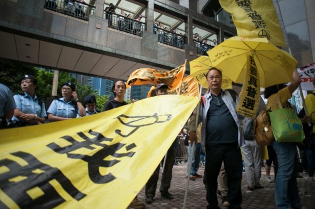 Protesters march in the Wan Chai district of Hong Kong on May 18, 2016 calling for univers