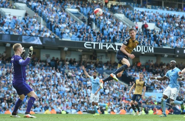Arsenal's defender Laurent Koscielny (3R) heads the ball by Manchester City's goalkeeper J