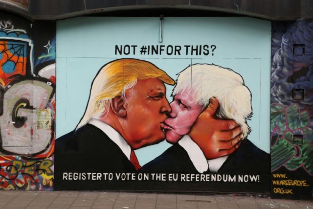 A mural showing likely US Republican presidential nominee Donald Trump (L) kissing the For