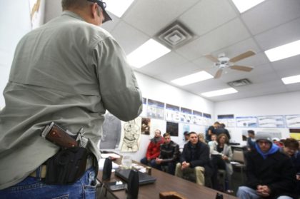 A gun instructor teaches a class to obtain a concealed gun carry permit