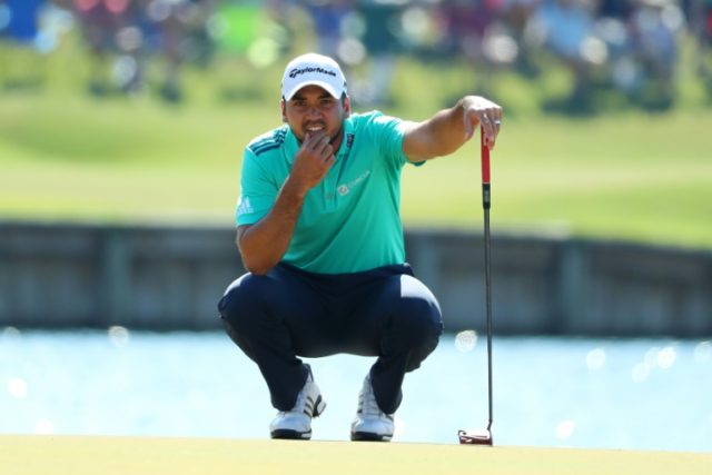 Jason Day of Australia lines up a putt on the 17th during the resumption of the weather-de