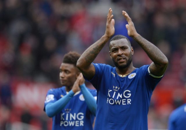 Leicester City's Jamaican defender Wes Morgan (R) applauds fans after the English Premier