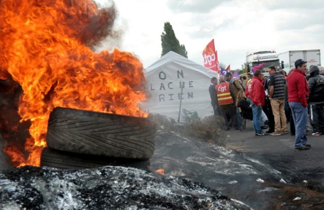 French union members burn tyres as they protest against the proposed government labour ref