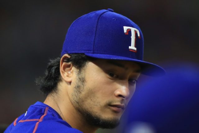 Yu Darvish of the Texas Rangers sits in the dugout during play against the New York Yankee