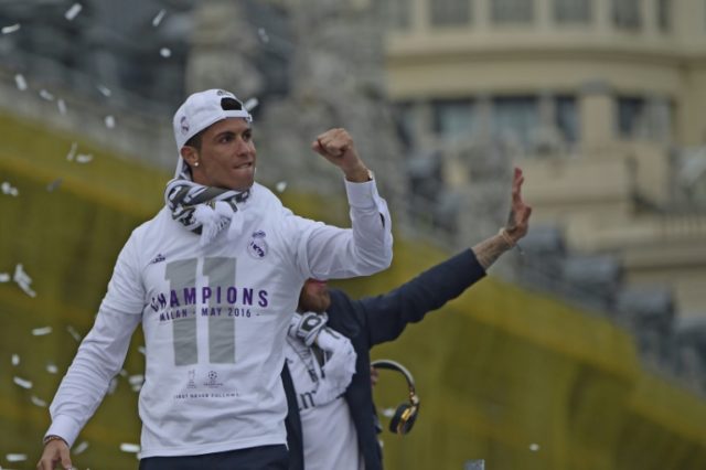Real Madrid's Cristiano Ronaldo celebrates with the team and thousands of delirious fans o