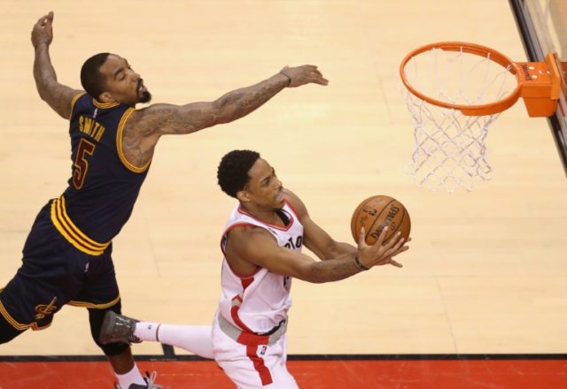 DeMar DeRozan of the Toronto Raptors shoots the ball against J.R. Smith of the Cleveland C