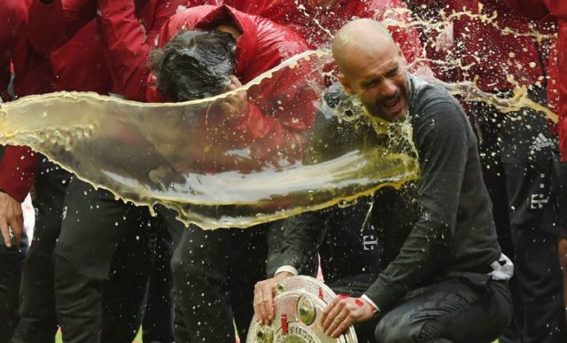 Bayern Munich head coach Pep Guardiola is doused in beer by Bayern Munich's David Alaba (L