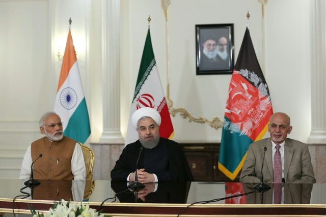 Iranian President Hassan Rouhani (centre) speaks at a joint press briefing with Indian Pri