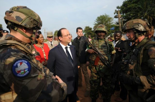 French President Francois Hollande (centre) met peacekeepers during a 2014 visit to the Ce