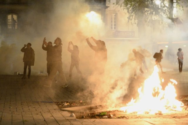 Protesters clash with riot police in Nantes during a demonstration over the French governm