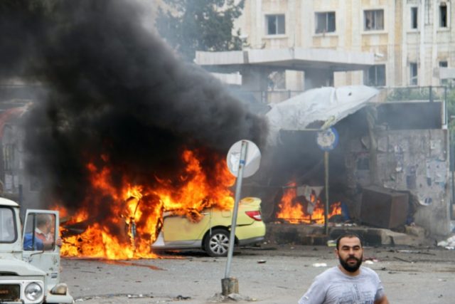 A car in flames at the scene of bombings in the Syrian city of Tartus, northwest of Damasc