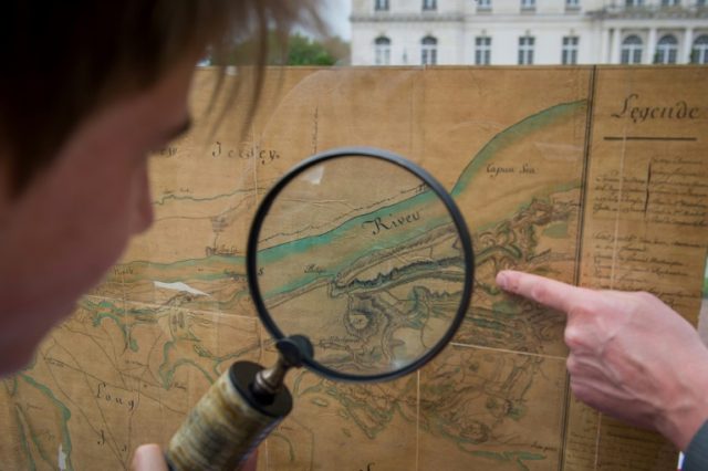 Auctioneer Aymeric Rouillac shows a Hudson River map from 1781 on May 16, 2016 in Montbazo