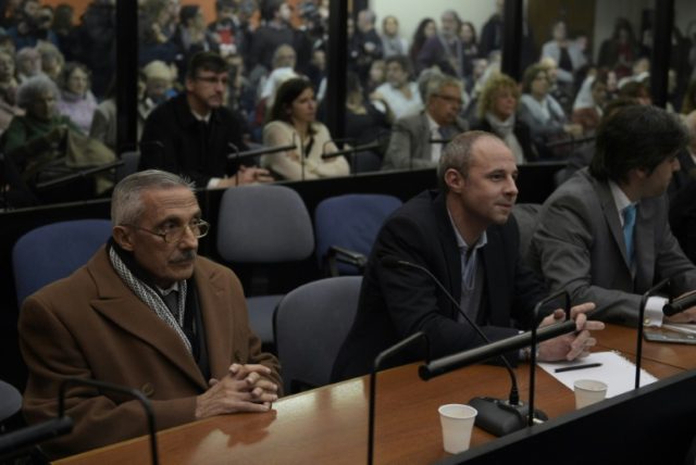 Former Argentine intelligence agent Miguel Angel Furci (L) waits to hear the sentence duri