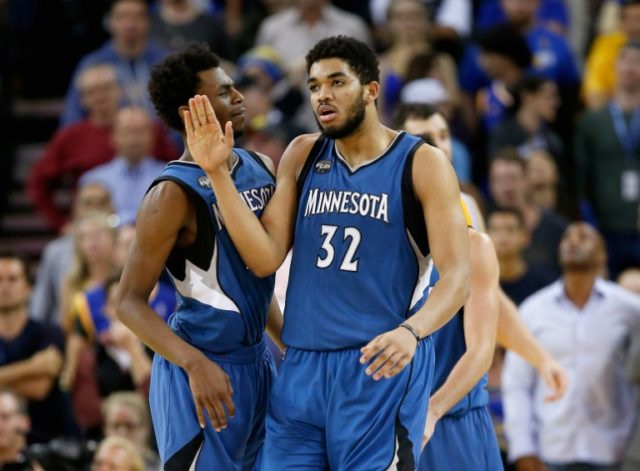 Karl-Anthony Towns #32 of the Minnesota Timberwolves is congratulated by Andrew Wiggins #2