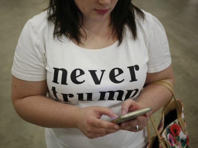 An attendee wears a 'Never Trump' shirt during a campaign event for Donald Trump, president and chief executive of Trump Organization Inc. and 2016 Republican presidential candidate, not pictured, in Indianapolis, Indiana, U.S., on Wednesday, April 20, 2016. Trump and Hillary Clinton won their New York presidential primaries Tuesday, ending …