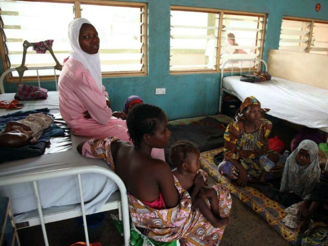 NIGERIA, Yola : Women and children rescued by Nigerian soldiers from Islamist militants Boko Haram at Sambisa Forest wait to receive treatment at the Federal Medical Centre in Yola on May 5, 2015. They were among a group of 275 people rescued by the Nigerian military last week and arrived …
