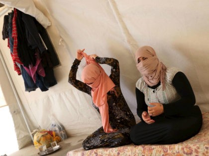 Yazidi sisters who escaped Islamic State captivity sit at Sharya refugee camp on the outskirts of Duhok province, July 3, 2015. REUTERS/Ari Jala