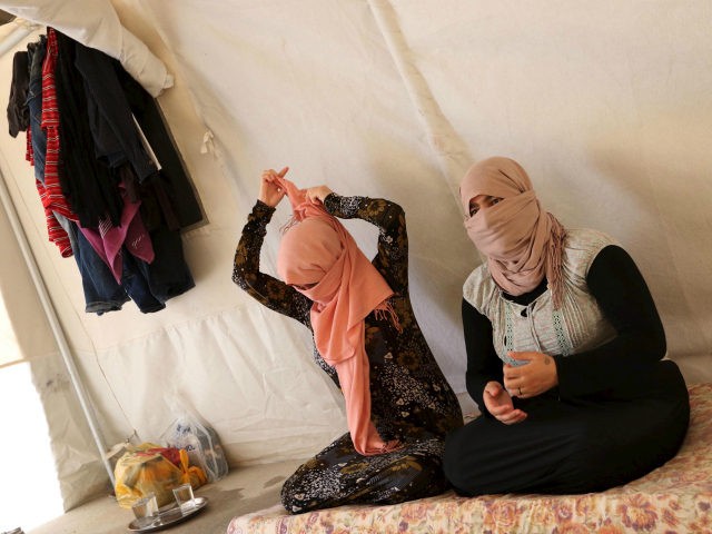 Yazidi sisters who escaped Islamic State captivity sit at Sharya refugee camp on the outsk