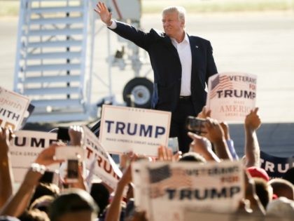 Republican presidential candidate Donald Trump waves to the crowd as he arrives to speak a