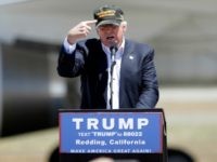 AP_16155811423963 Donald Trump, the presumptive Republican presidential nominee gestures to a his camouflaged "Make America Great" hat as he discuses his support by the National Rifle Association at a campaign rally at the Redding Municipal Airport Friday, June 3, 2016, in Redding, Calif. (AP Photo/Rich Pedroncelli)
